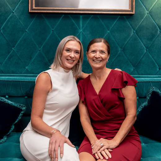 Two women smiling at the camara